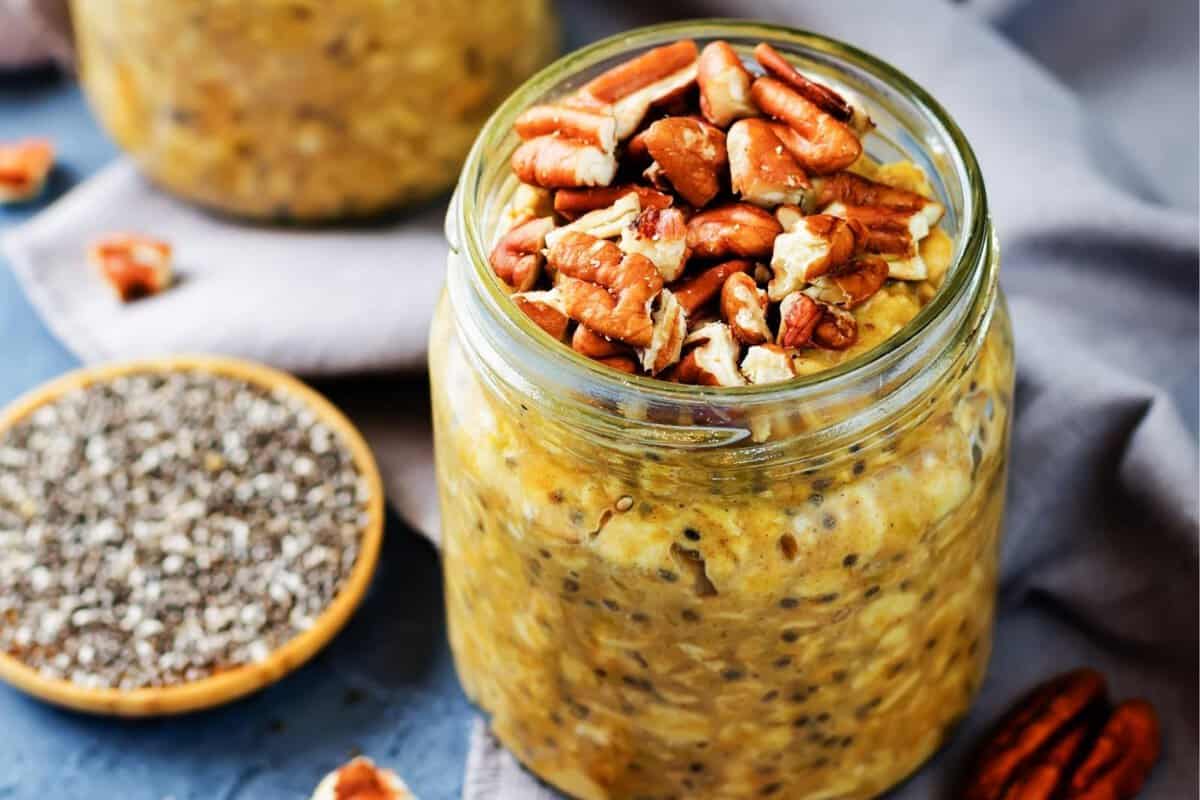 a jar of pumpkin pie overnight oats and a small bowl of chia seeds on the side