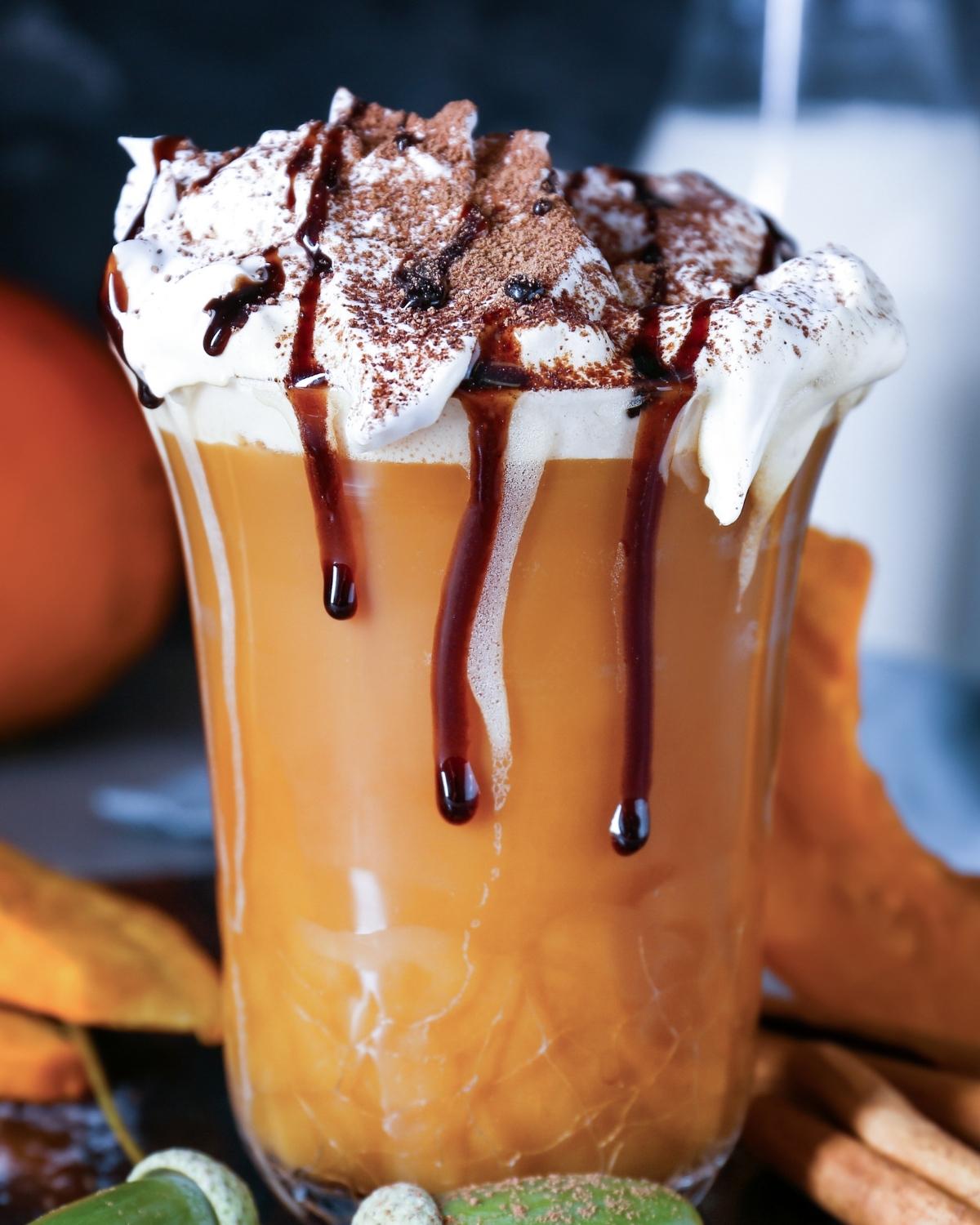 mug of pumpkin hot chocolate topped with whipped cream and chocolate
