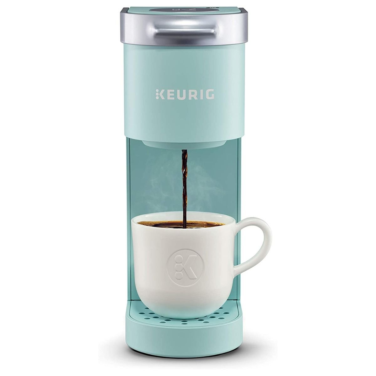 Light blue Keurig brewing coffee into a white mug.