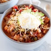 a bowl of chili with toppings