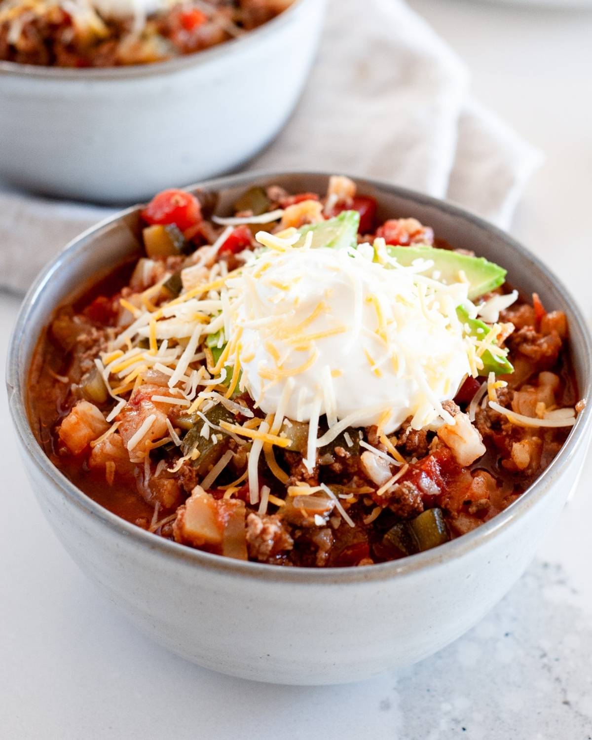 a bowl of chili with toppings