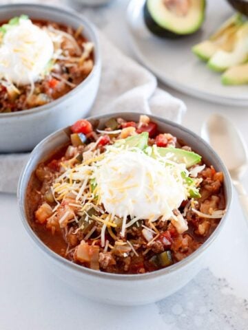 two bowls of keto chili with toppings
