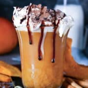 mug of pumpkin hot chocolate topped with whipped cream and chocolate