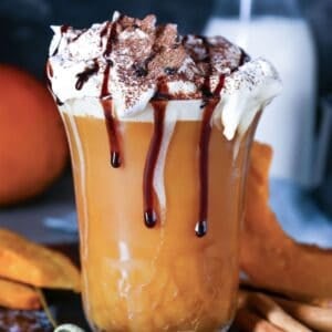 mug of pumpkin hot chocolate topped with whipped cream and chocolate