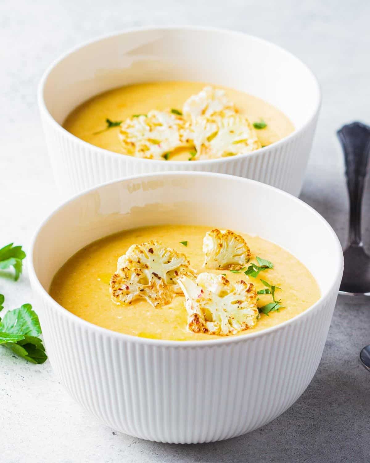 two bowls of roasted cauliflower soup