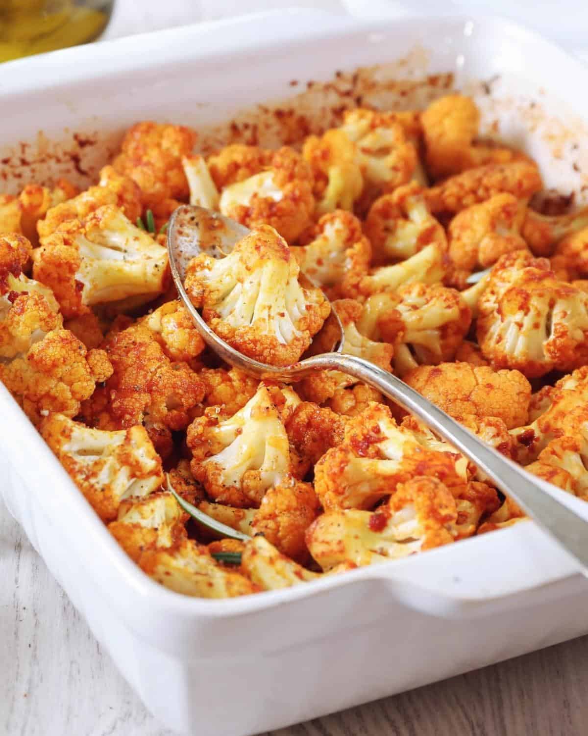 spicy roasted cauliflower florets in a while baking dish