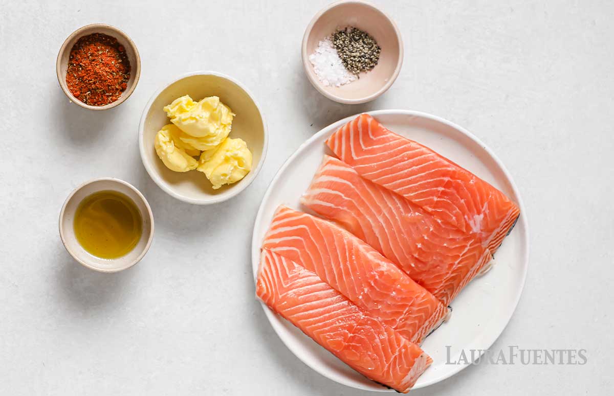 ingredients for cajun salmon in individual bowls and in a plate