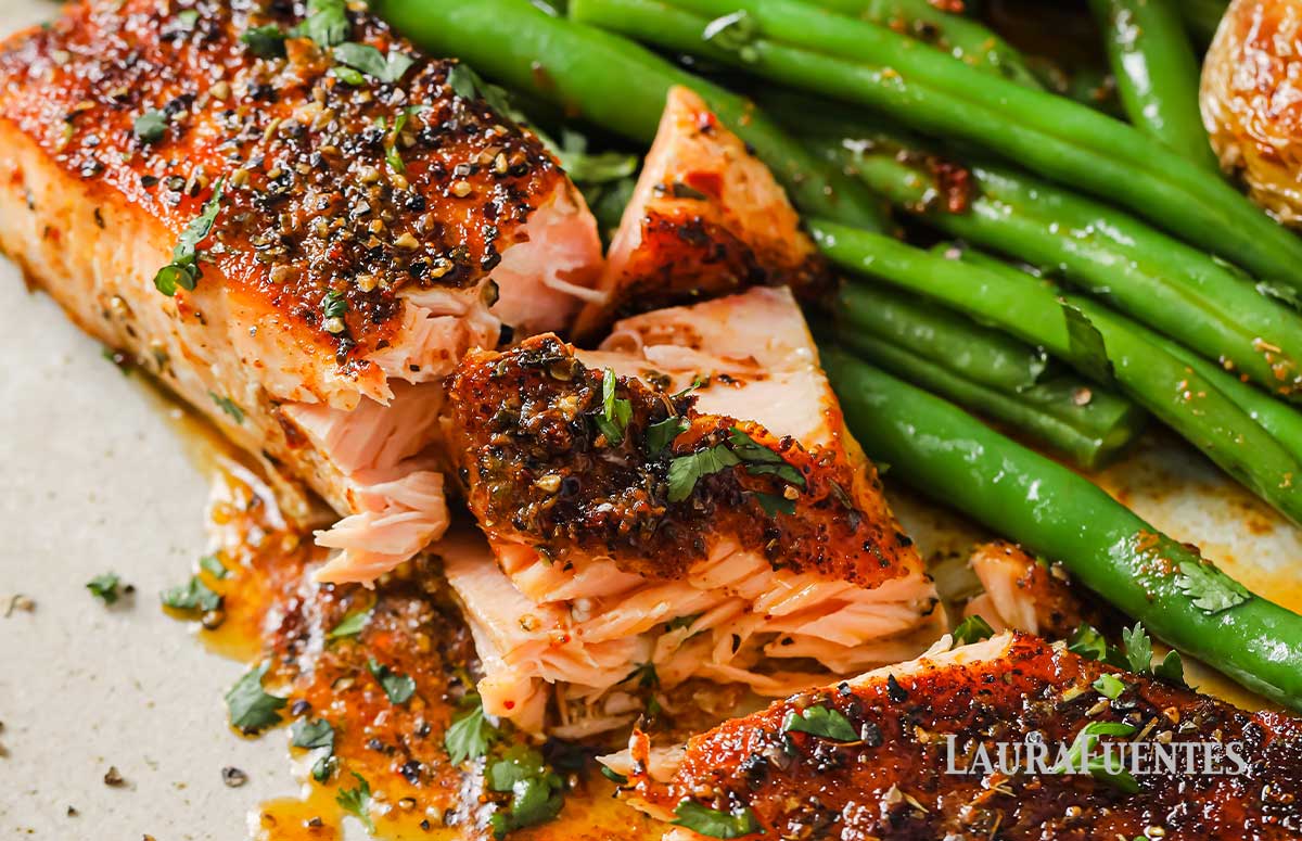 plate of flaky cajun salmon with green beans