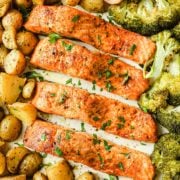salmon fillets, broccoli and potatoes on a roasting sheet