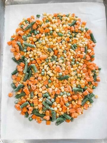 frozen vegetables in a lined baking sheet