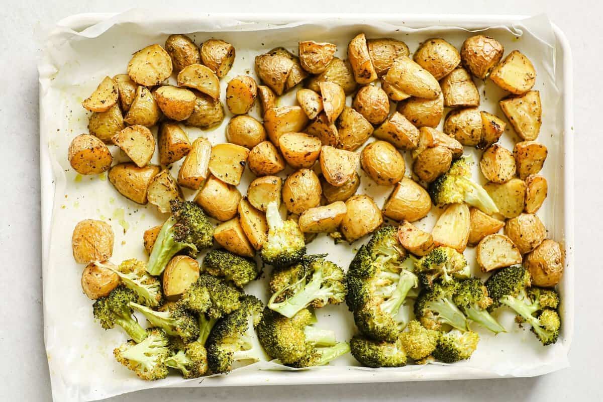 overhead view of roasted potatoes and broccoli on the same sheet pan