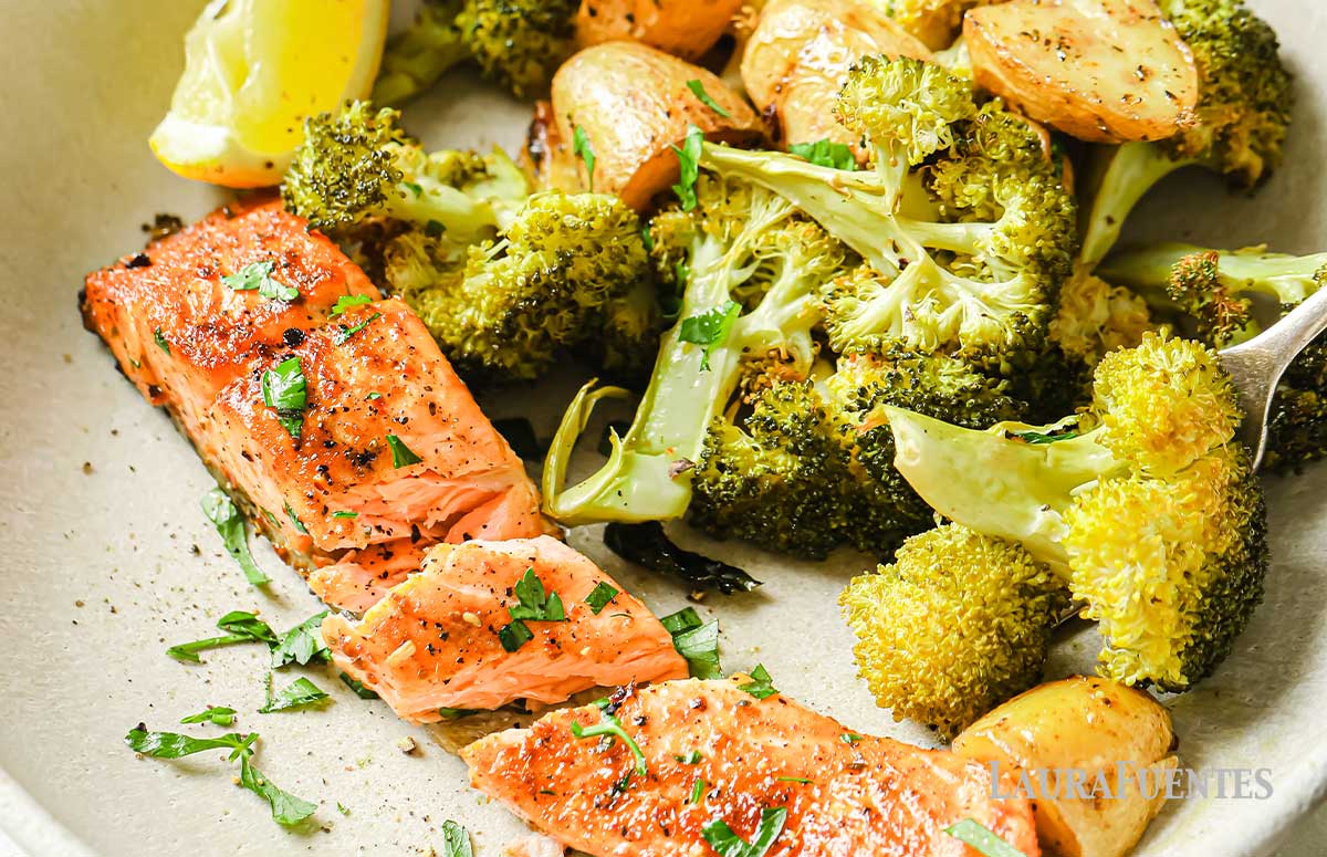 roasted potatoes and broccoli on a plate with a slice of salmon