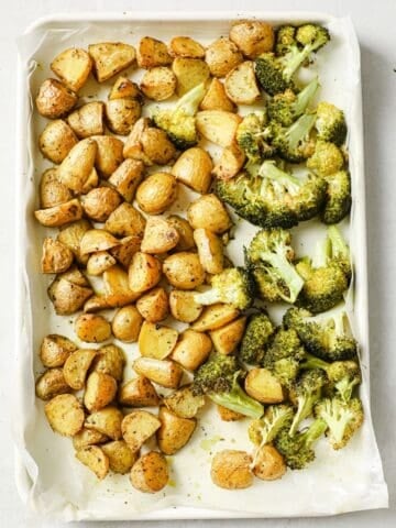 overhead view of roasted potatoes and broccoli on the same sheet pan
