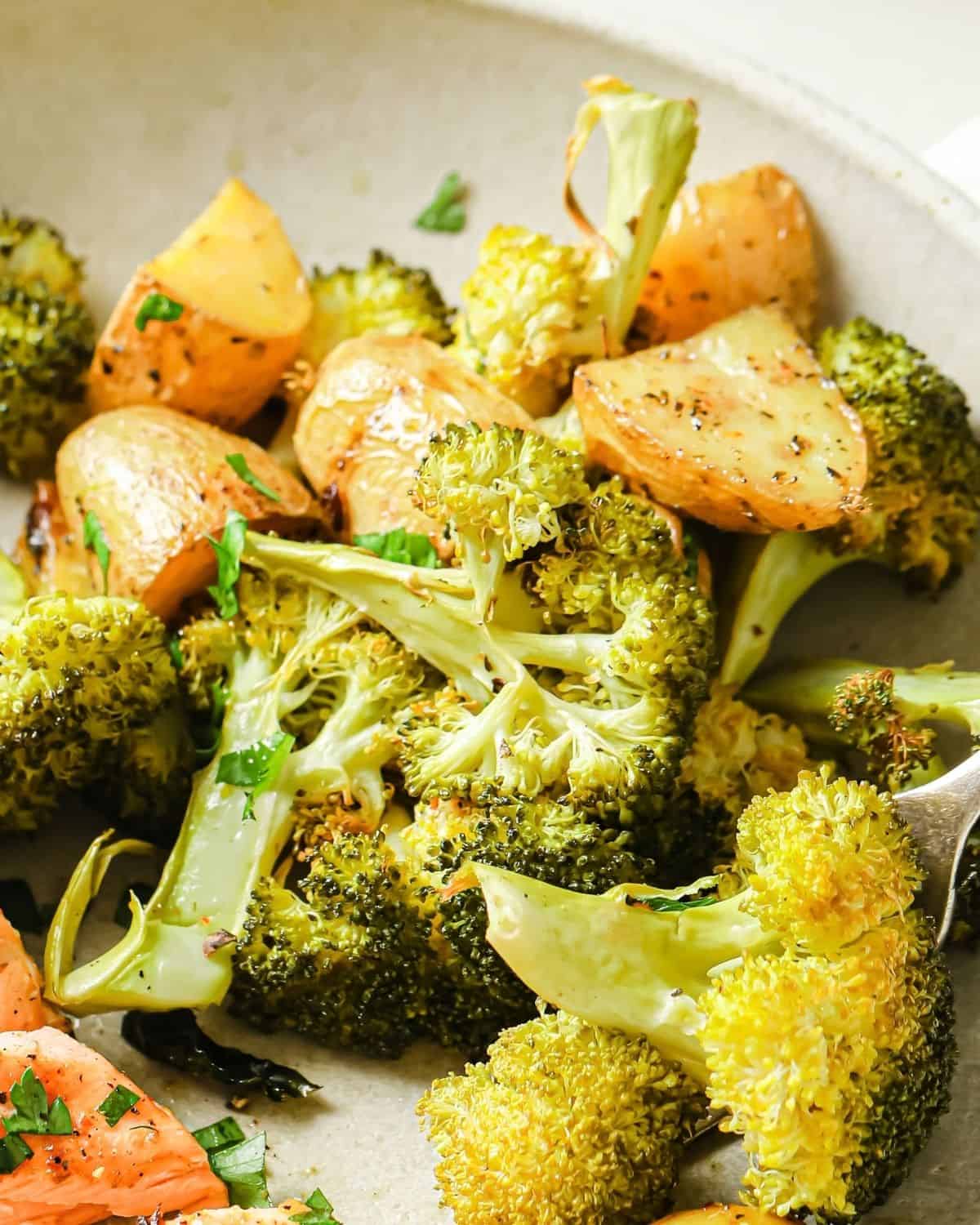 close up of roasted potatoes and broccoli on a plate