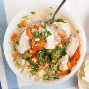 overhead view of chicken pot pie soup in a white bowl