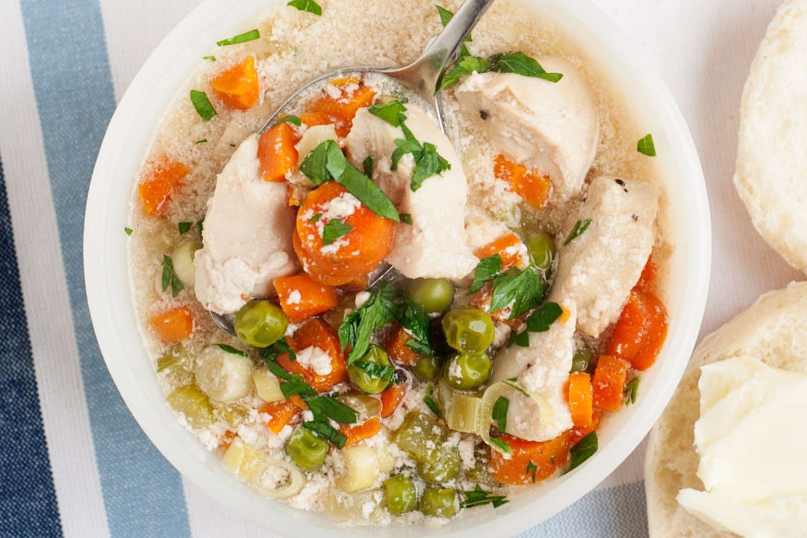 overhead view of chicken pot pie soup in a white bowl