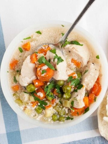overhead view of chicken pot pie soup in a white bowl