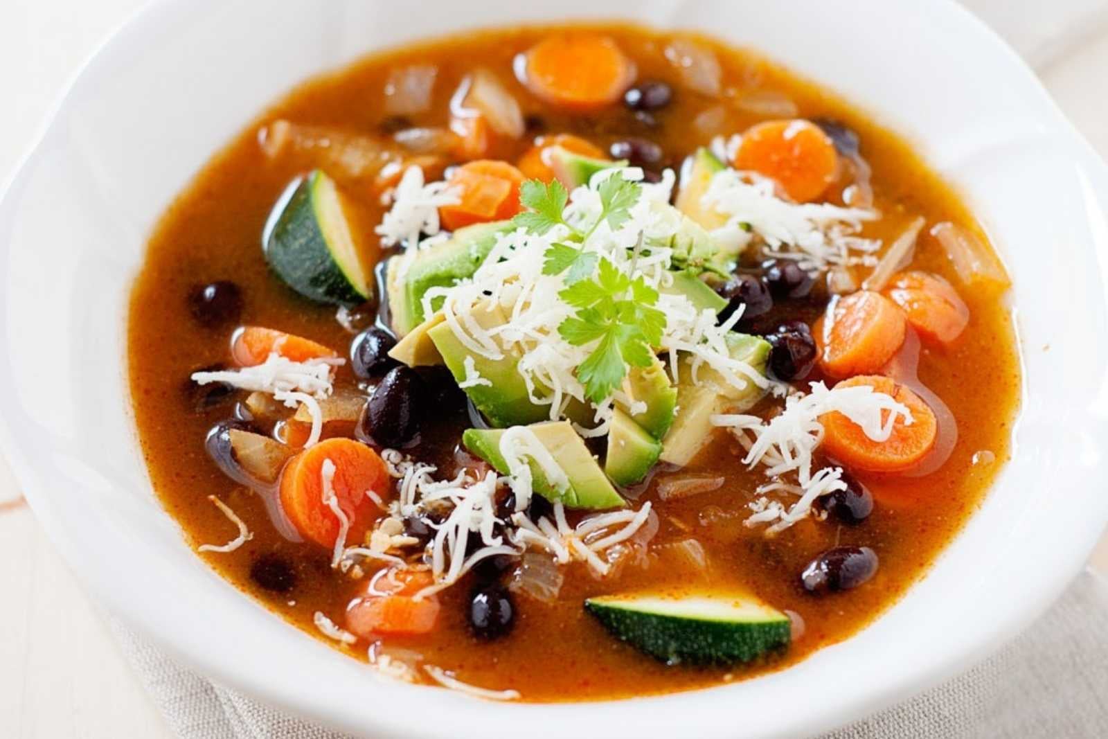 vegetable soup with black beans and zucchini in a bowl