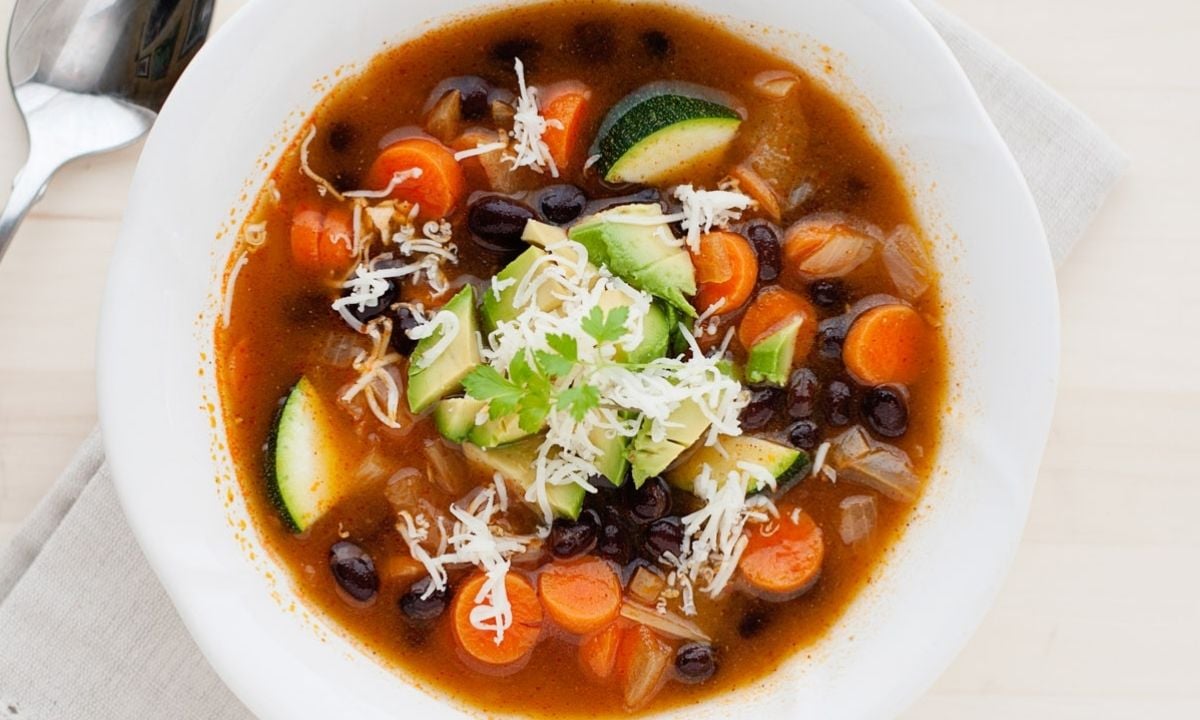 vegetable soup with black beans and zucchini in a bowl