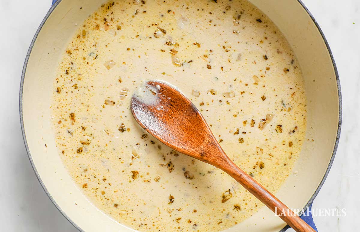 large bowl of lemon garlic sauce with a wooden spoon