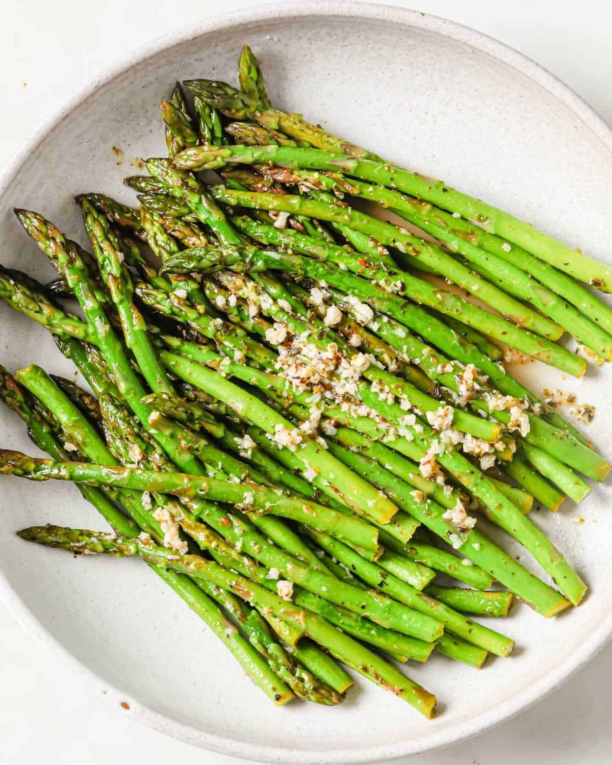 lemon garlic asparagus in a white plate