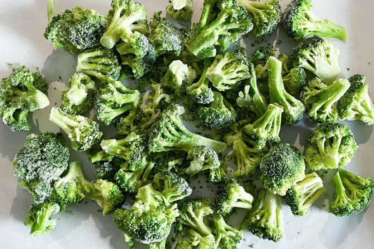 frozen broccoli on a parchment lined baking sheet