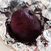 three beets wrapped in foil after roasting