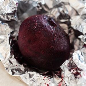 three beets wrapped in foil after roasting