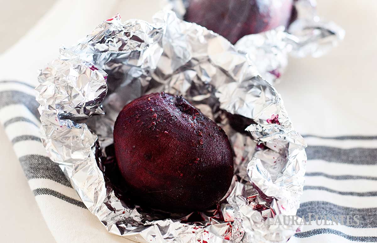 three beets wrapped in foil after roasting