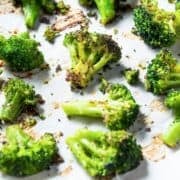 large baking sheet of roasted broccoli with seasoning