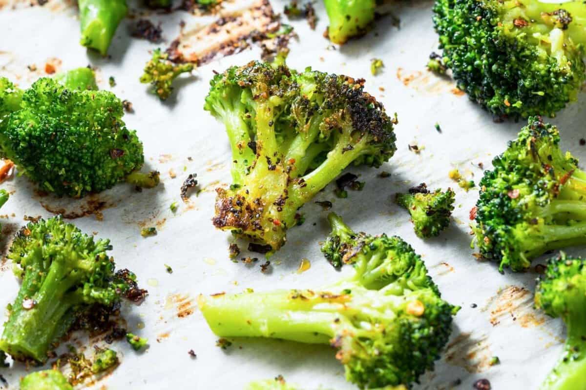 large baking sheet of roasted broccoli with seasoning