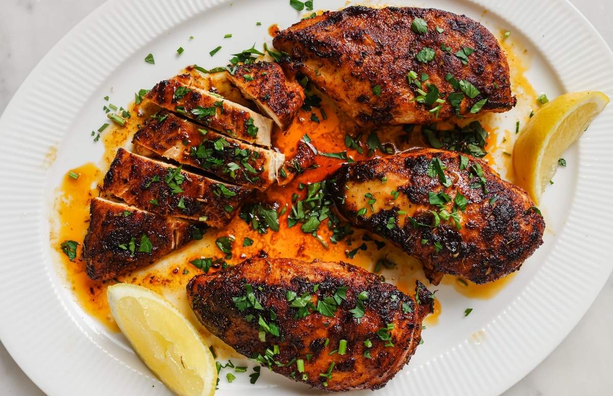 pan-grilled chicken breasts in a white dish