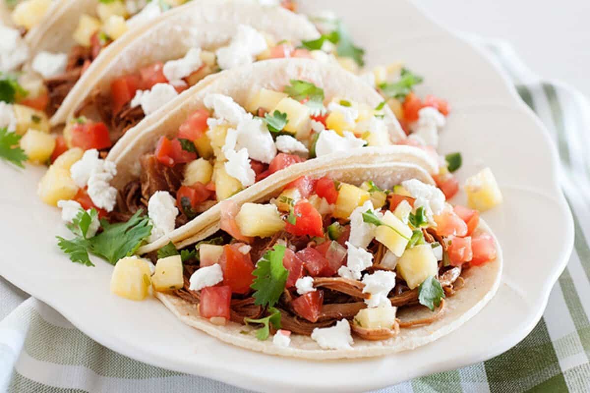 pineapple pork tacos on a plate