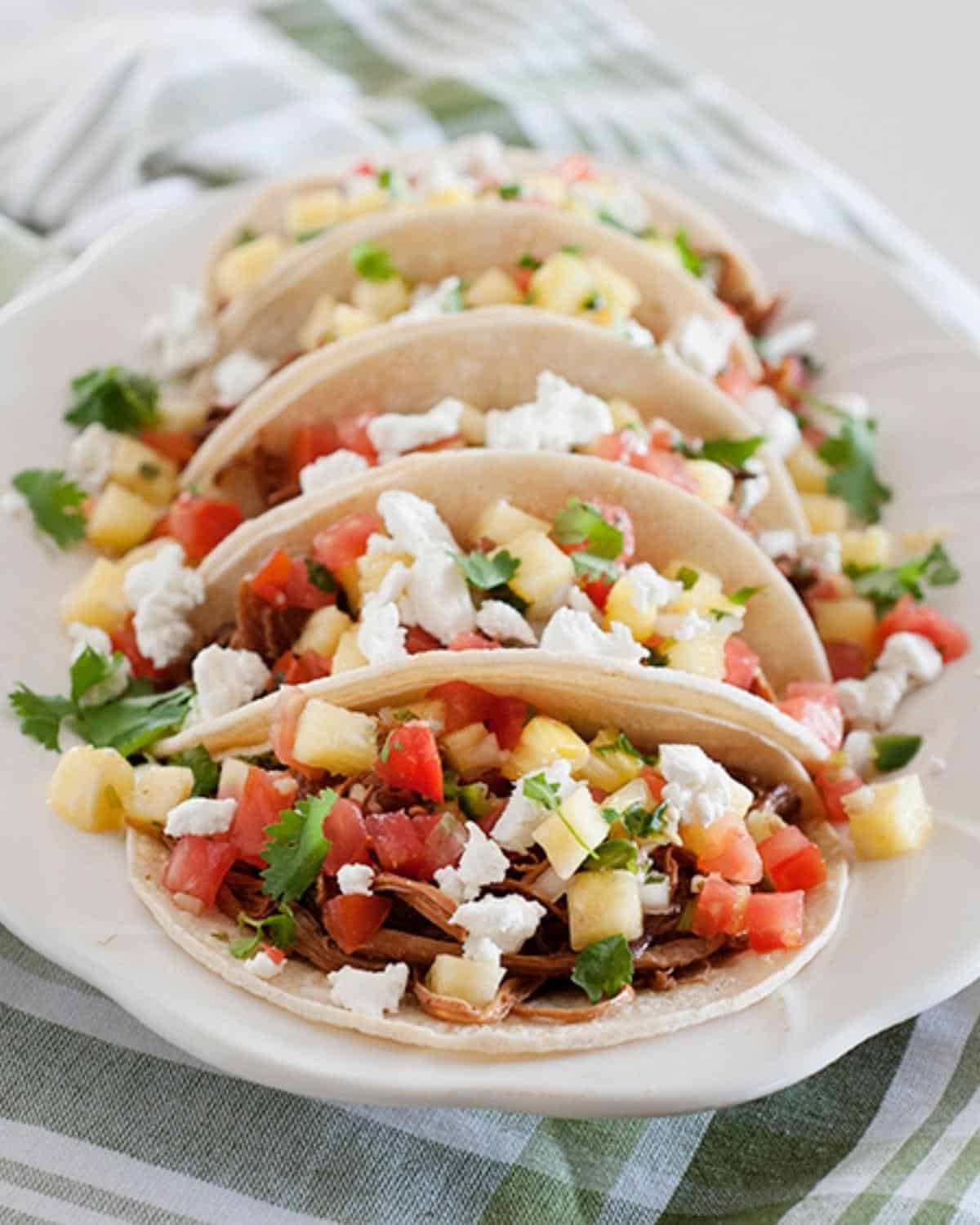 pineapple pork tacos on a plate