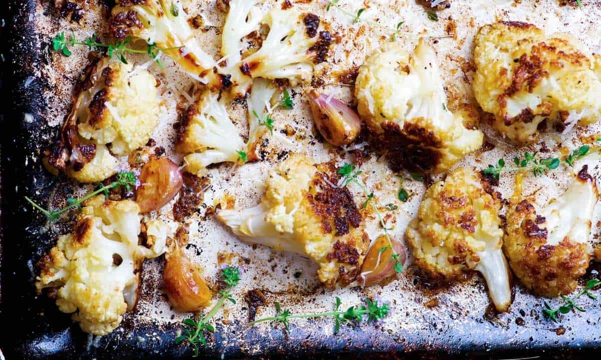closeup of roasted cauliflower florets in a baking sheet
