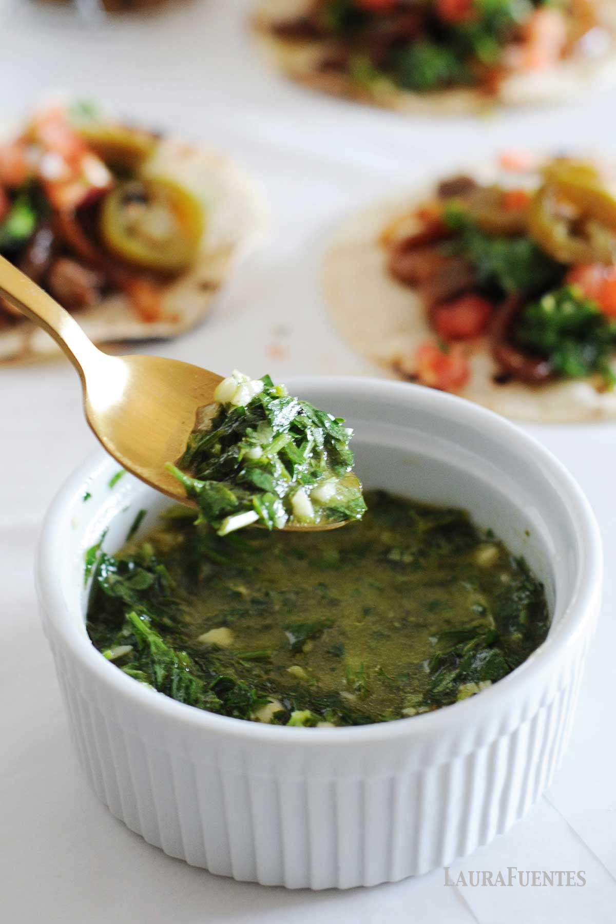 a spoon and a bowl of cilantro chimichurri