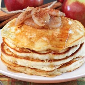 stack of apple pancakes topped with cinnamon apples