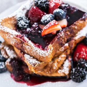 closeup of stack of blueberry french toast topped with berries
