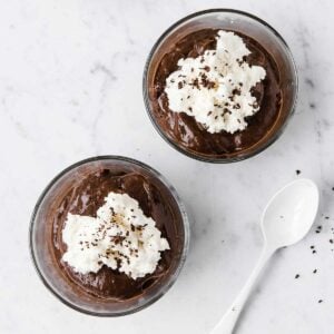 two small bowls of chocolate avocado mousse