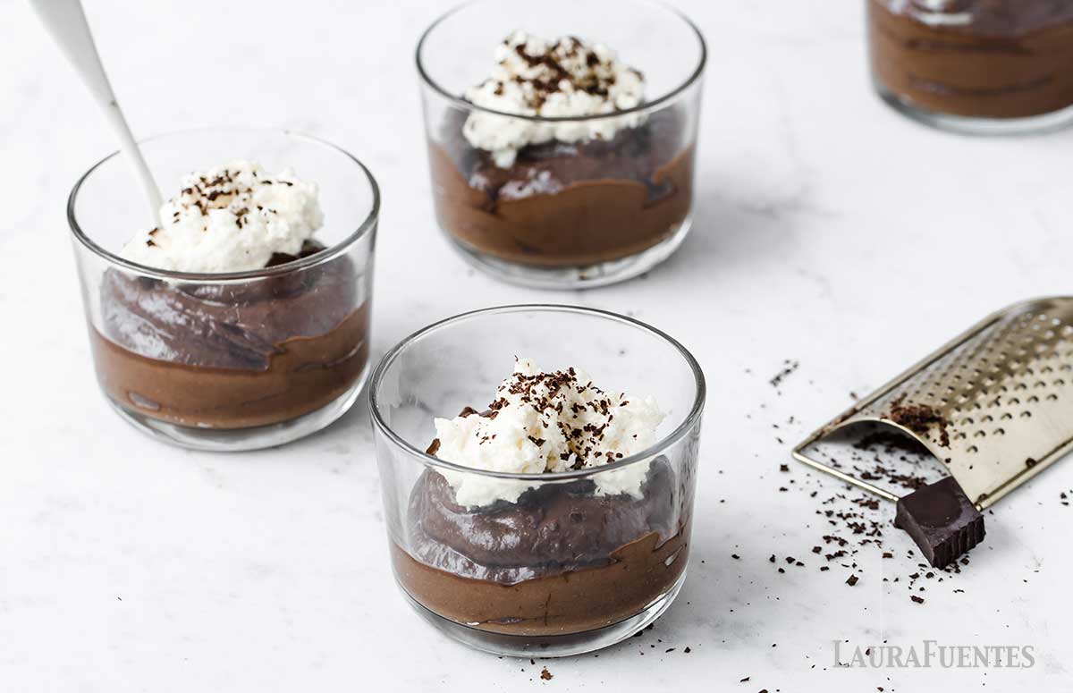 three small bowls of chocolate avocado mousse