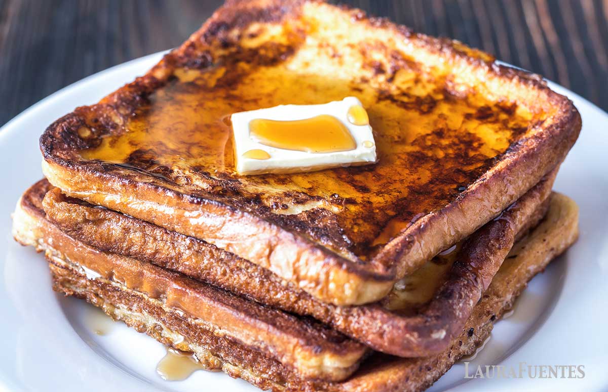 stack of French toast topped with butter and syrup