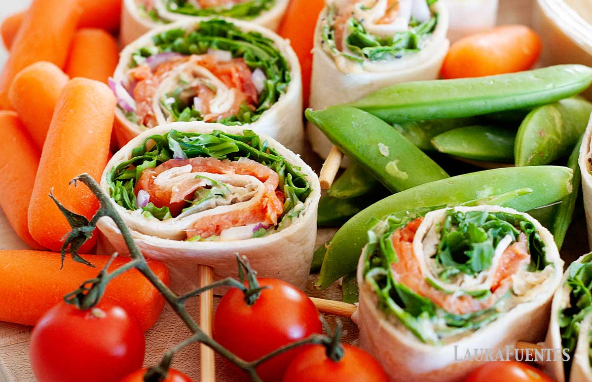 smoked salmon pinwheels with baby carrots, cherry tomatoes and snap peas