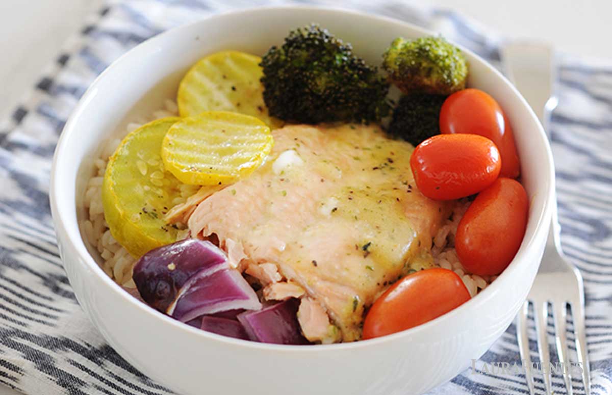salmon in a bowl with rice and vegetables