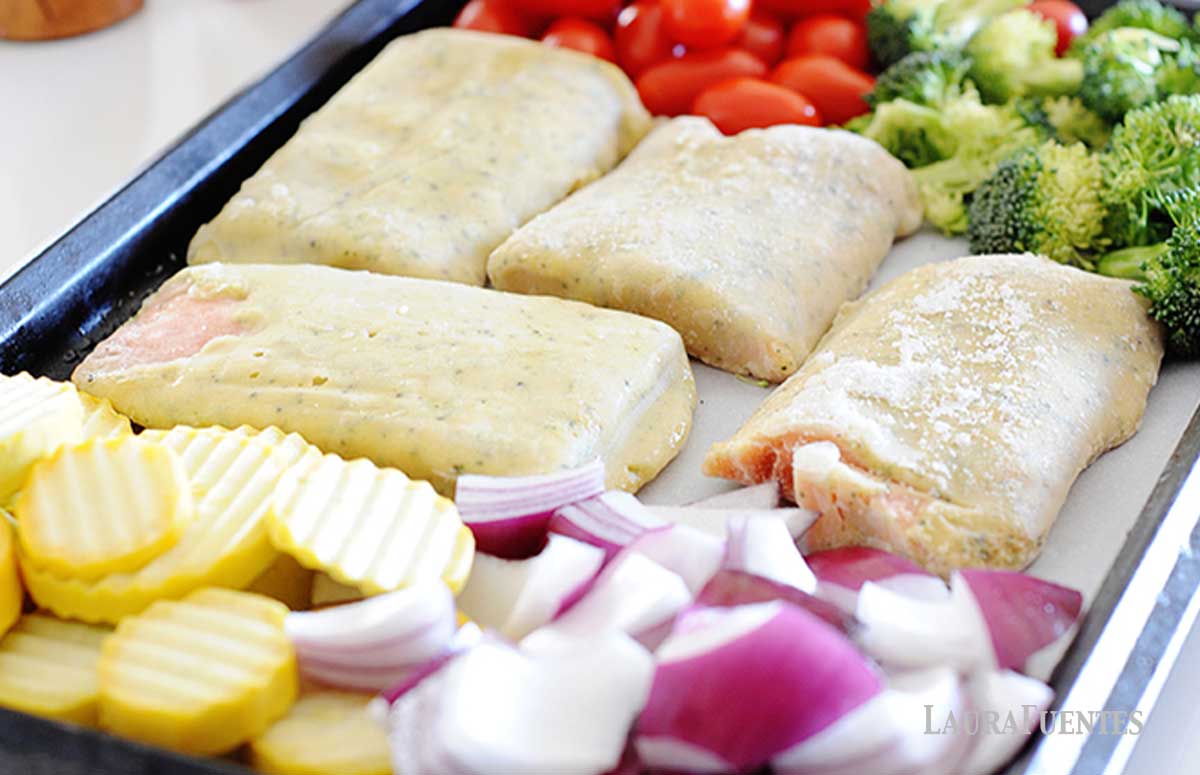 sheet pan with frozen salmon and chopped vegetables