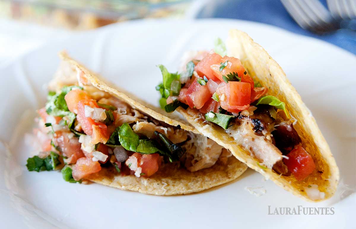 two rotisserie chicken tacos on a plate