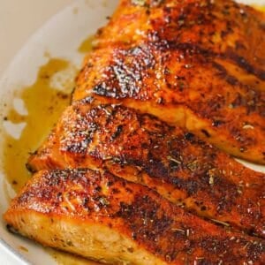 four salmon fillets in a pan