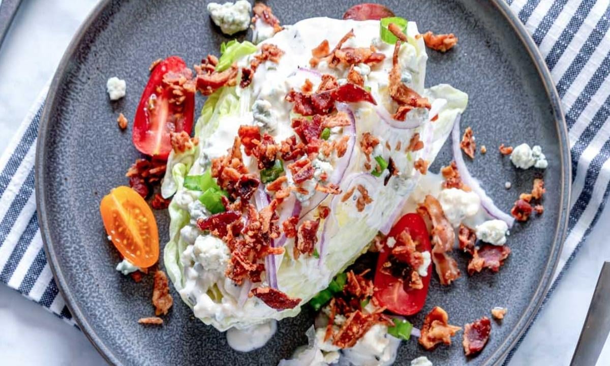 top view of wedge salad with toppins in a gray dish
