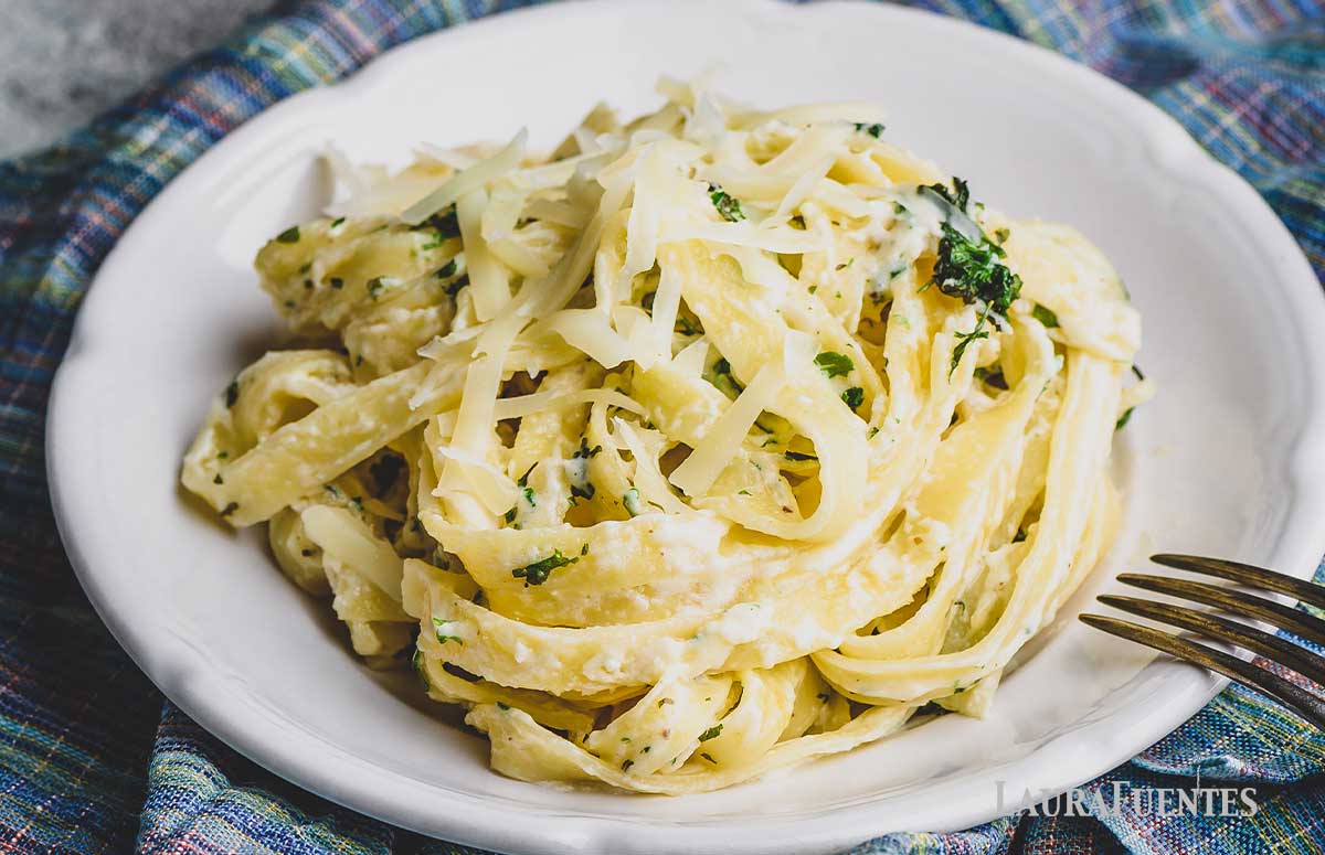a dish with pasta and alfredo sauce  made with half and half 