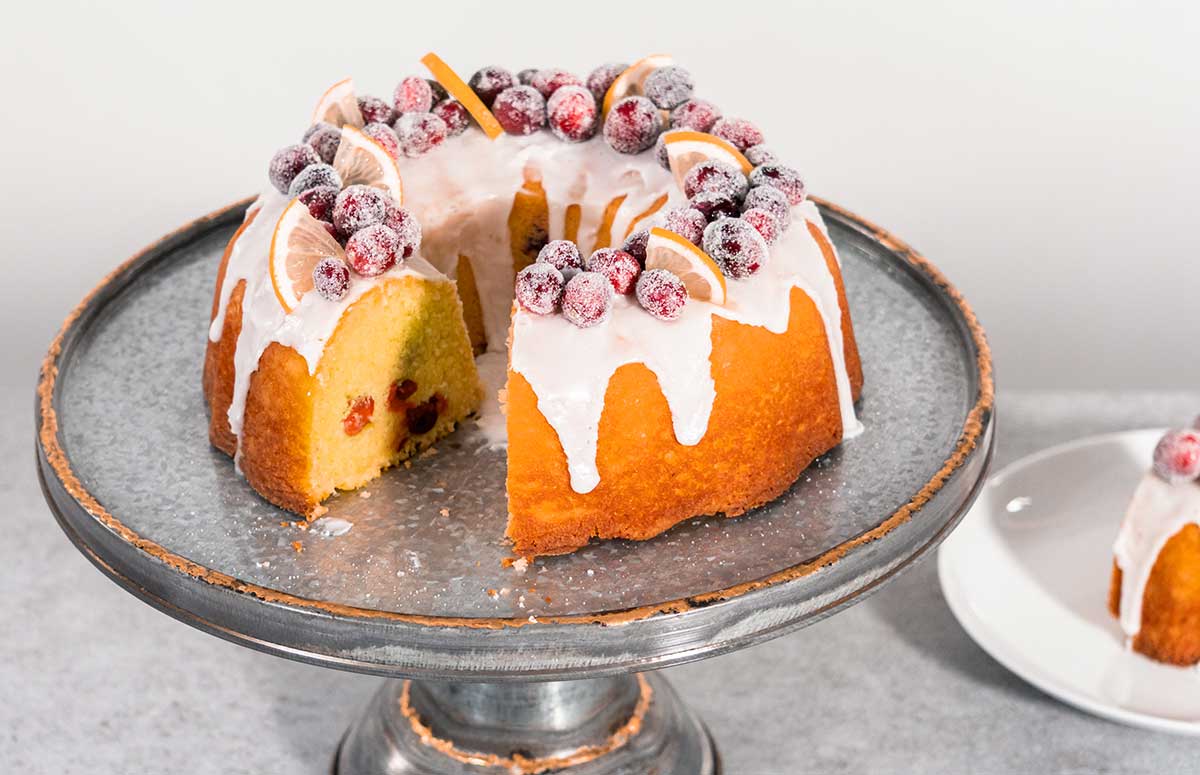 cranberry orange bundt cake topped with sugared cranberries