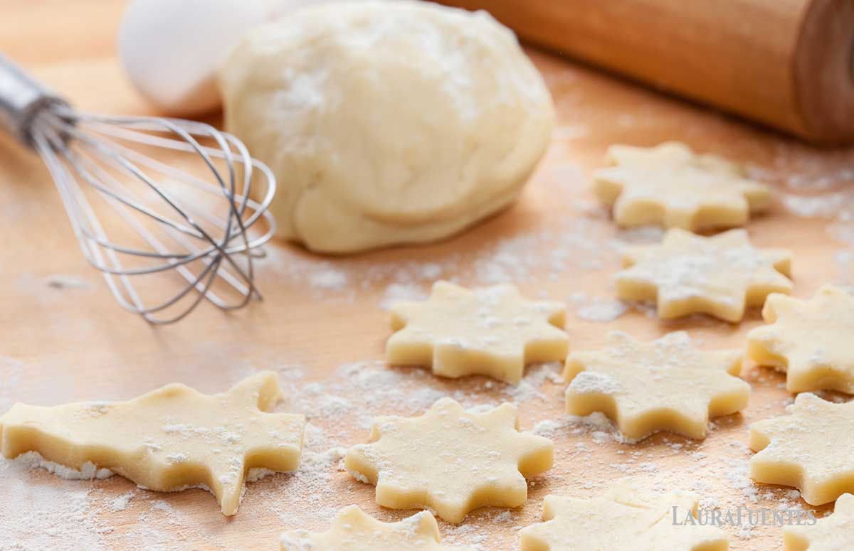 cookie dough being rolled into shapes